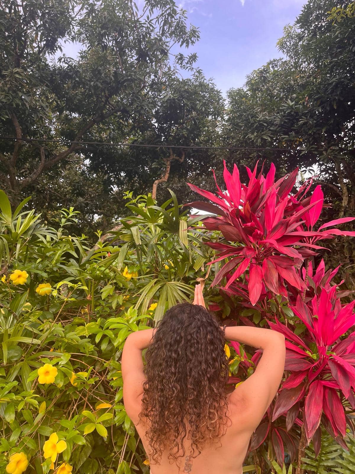 Quiet moment of practice surrounded by lush garden greenery